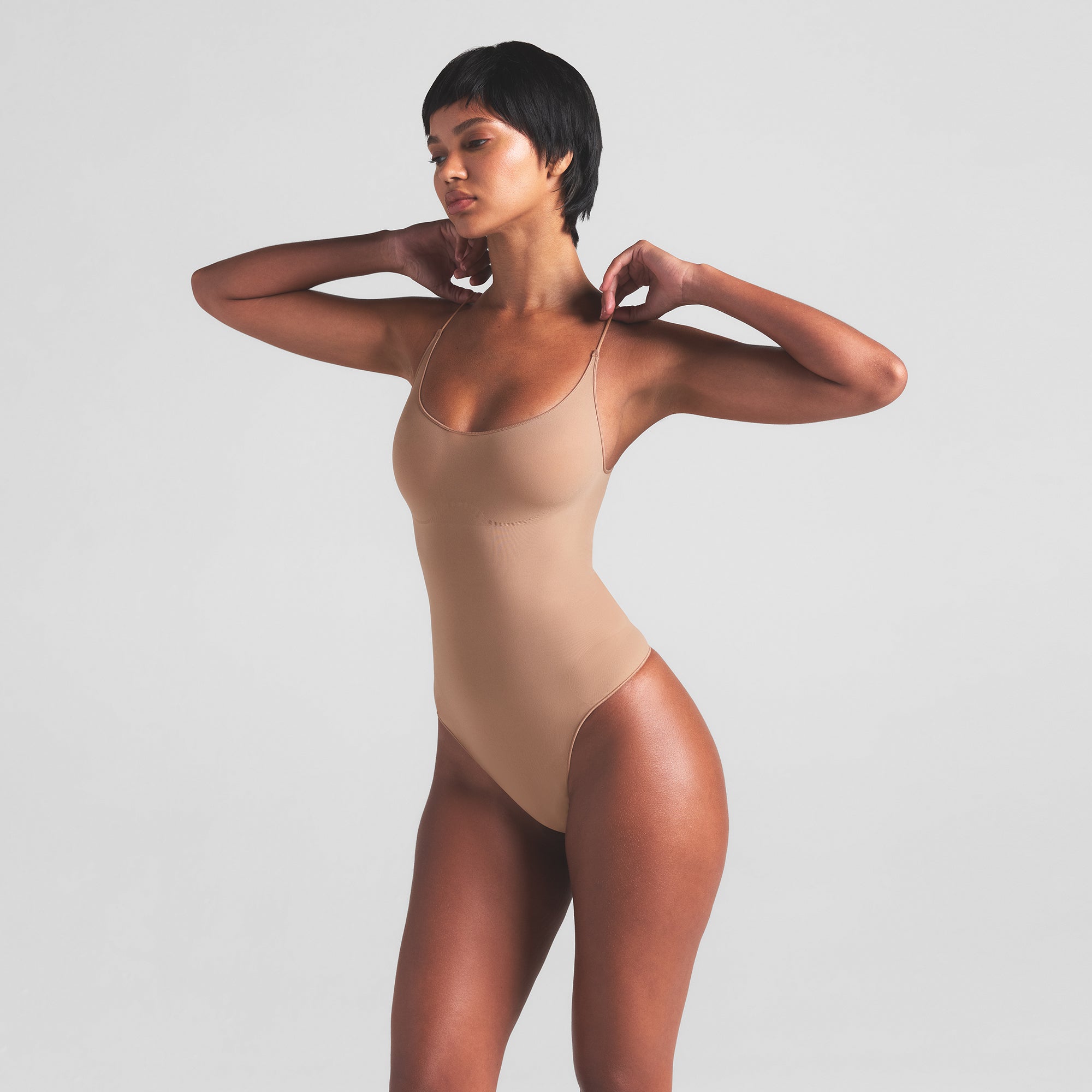 SHEER SEAMLESS THONG BODYSUIT | SIENNA ON A MODEL SIDE VIEW | FOCUS: 0.0, 1.0, 0.9