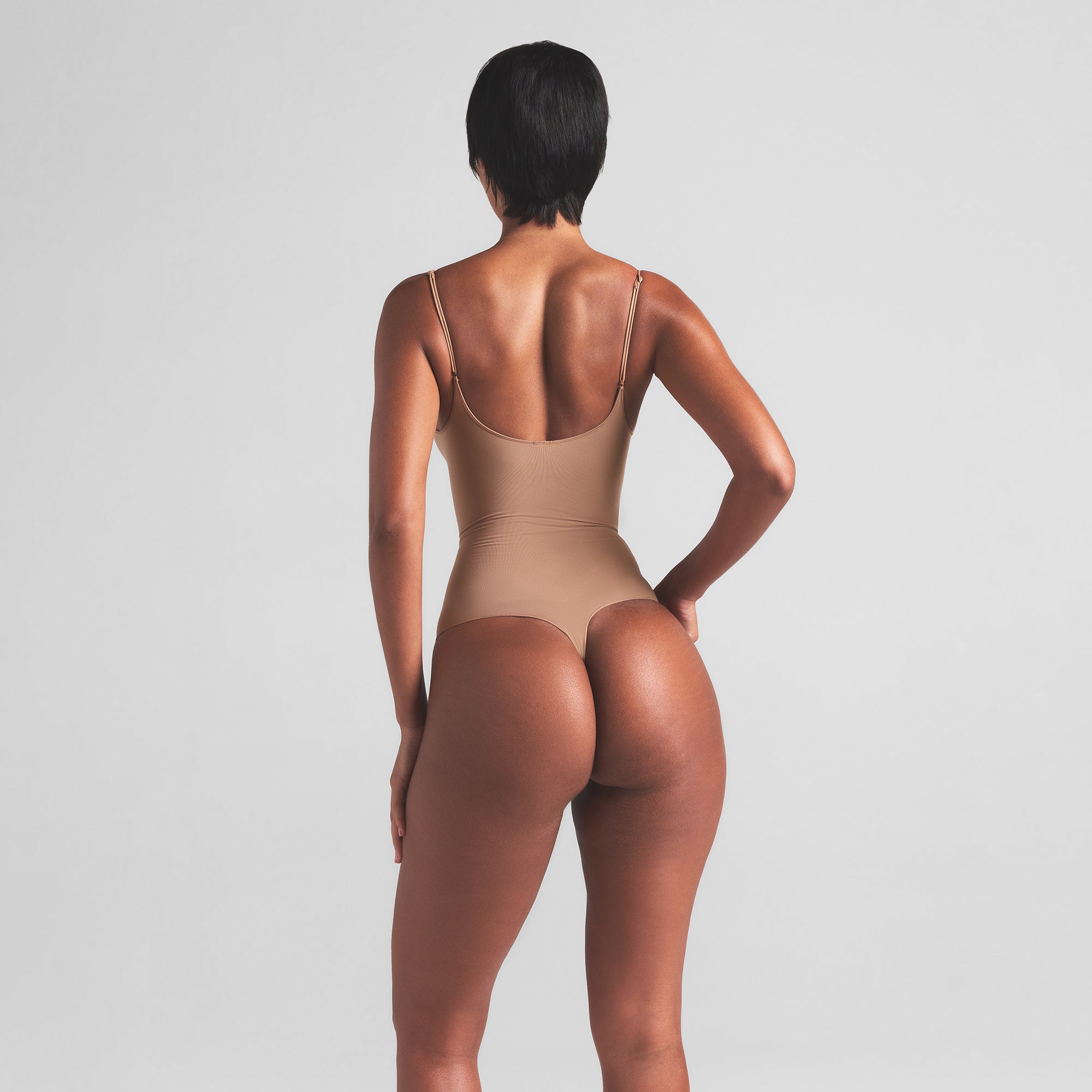 SHEER SEAMLESS THONG BODYSUIT | SIENNA ON A MODEL BACK VIEW | FOCUS: 0.0, 1.0, 0.9