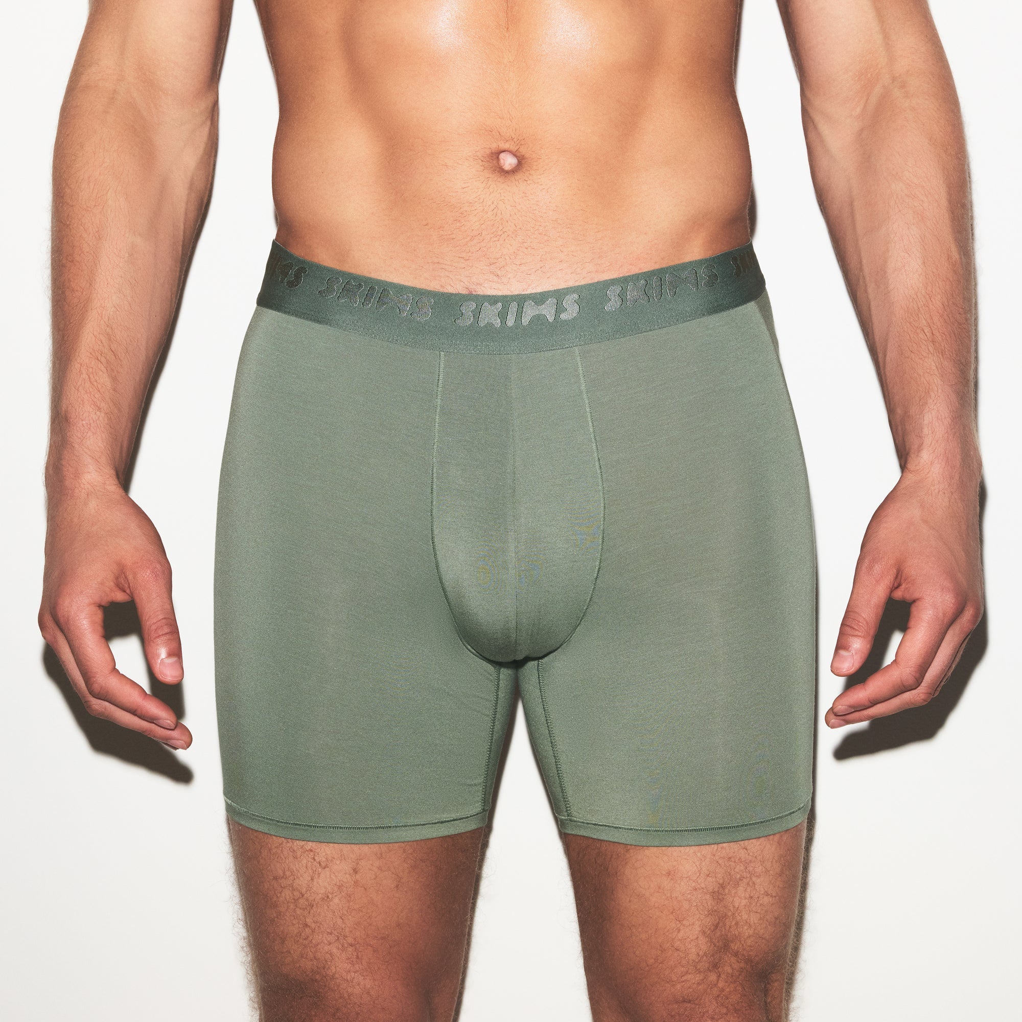 SKIMS STRETCH MENS 3 INCH BOXER BRIEF 3-PACK | LAUREL MULTI ON A MODEL SIDE VIEW | FOCUS: 0.0, 1.0, 0.9
