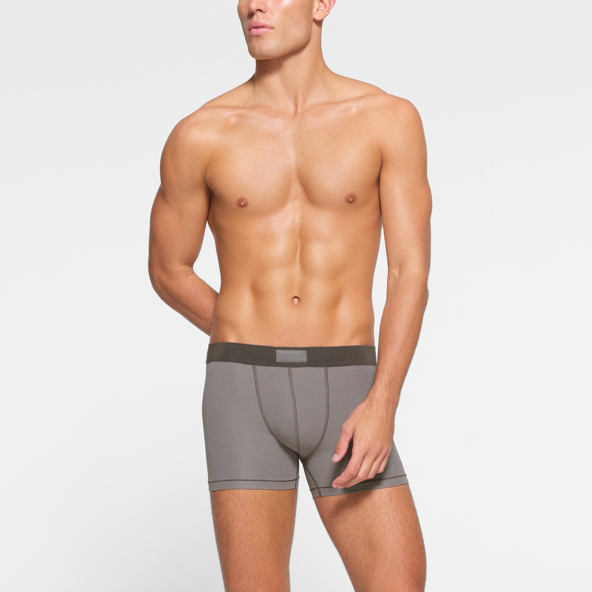 SKIMS COTTON MENS 3" BOXER BRIEF 3-PACK WORN BY A MODEL IN FRONT VIEW