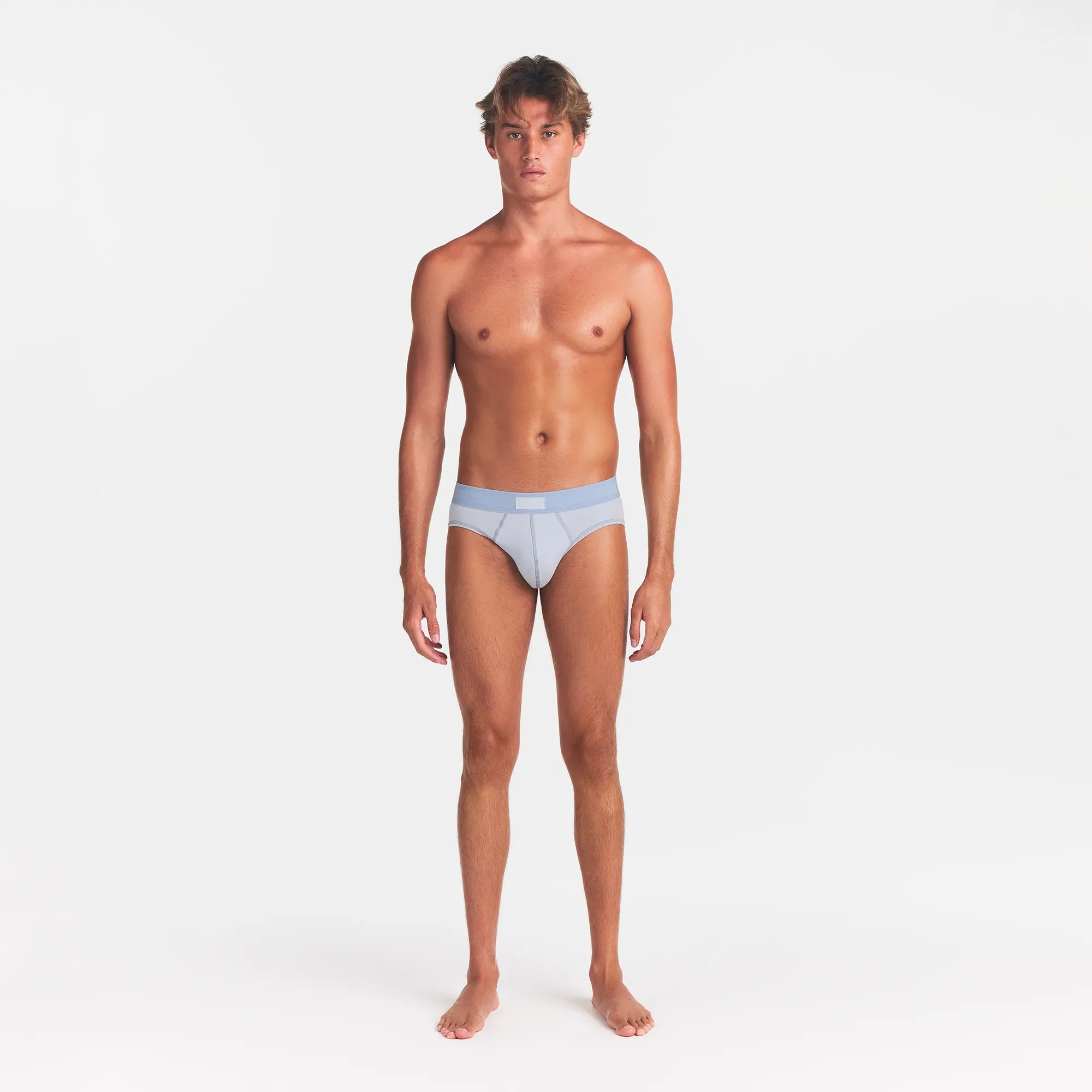 SKIMS COTTON MENS BRIEF 3-PACK | NIMBUS MULTI ON A MODEL FRONT VIEW @ | FOCUS: 0.0, 1.0, 0.9