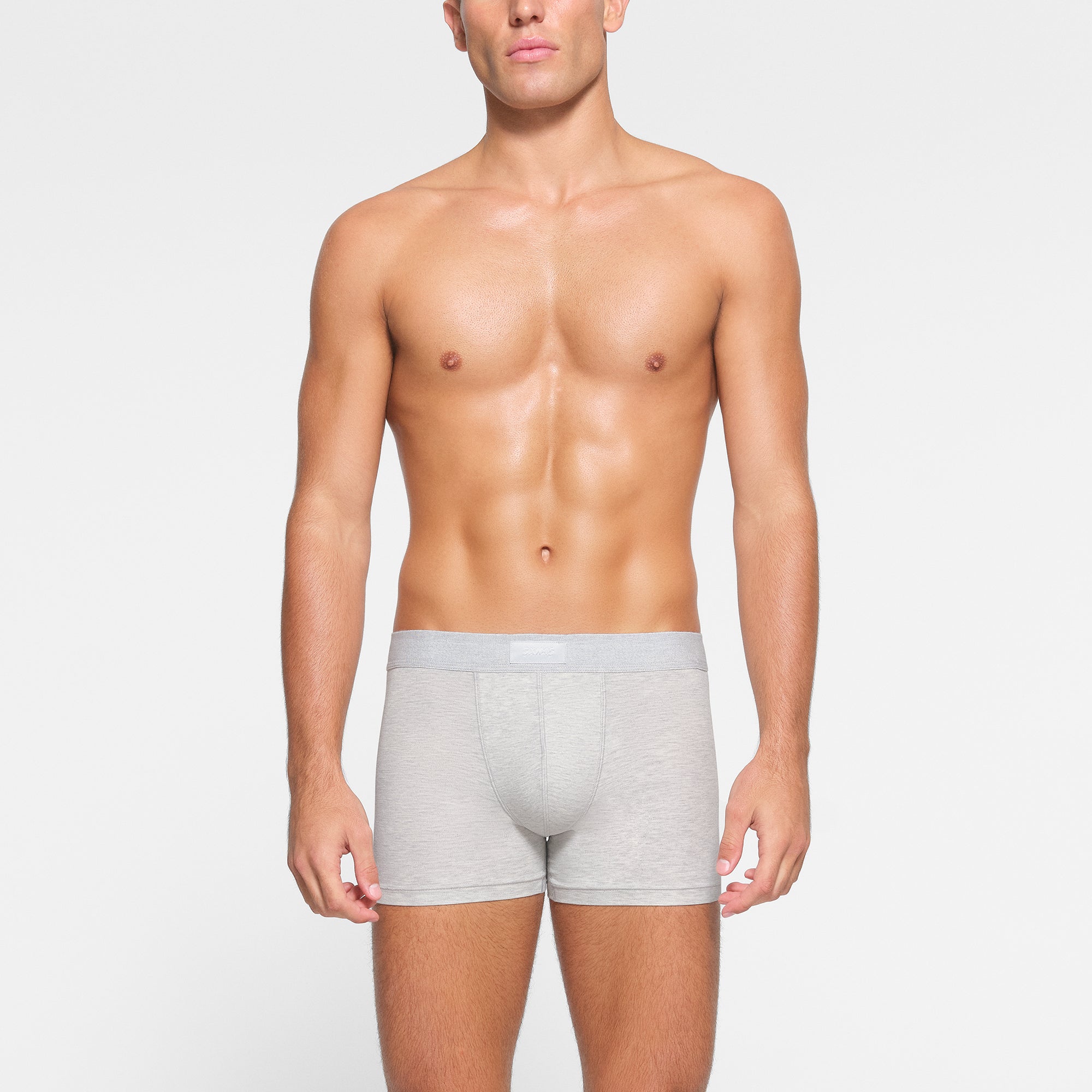 SKIMS COTTON MENS 3" BOXER BRIEF 3-PACK WORN BY A MODEL IN FRONT VIEW
