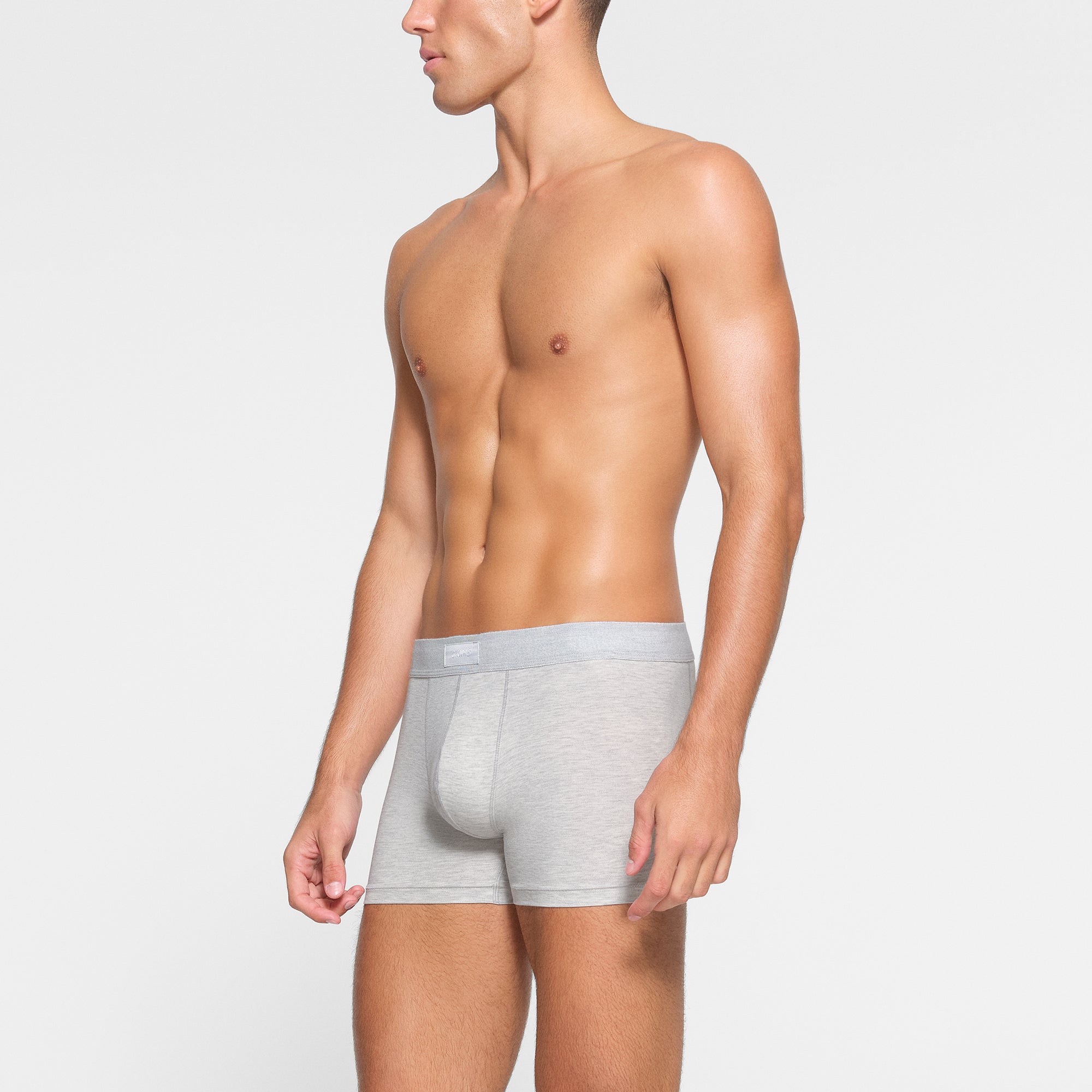 SKIMS COTTON MENS 3" BOXER BRIEF 3-PACK WORN BY A MODEL IN SIDE VIEW