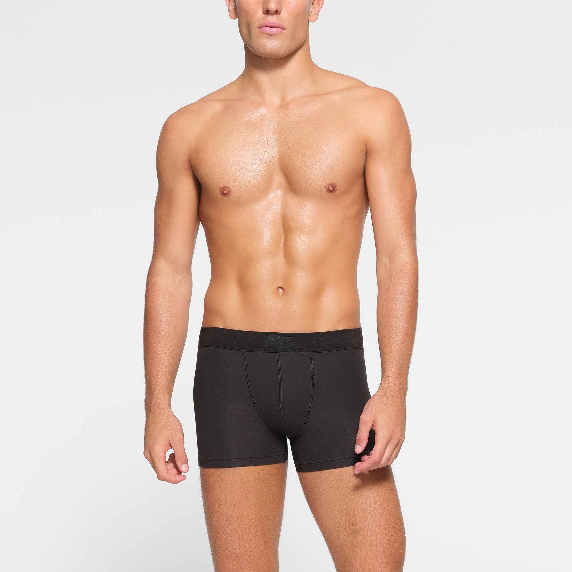 SKIMS COTTON MENS 3" BOXER BRIEF 3-PACK WORN BY A MODEL IN FRONT VIEW