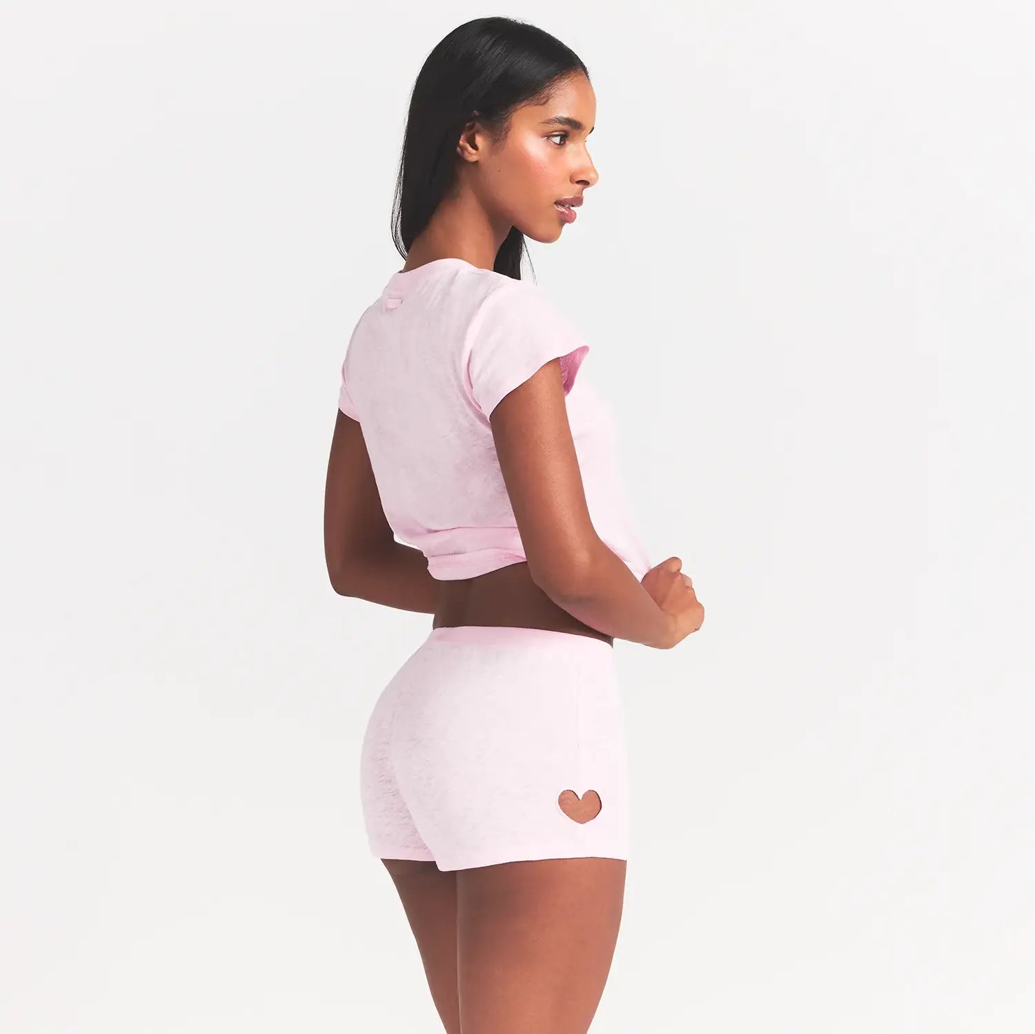 WORN IN JERSEY MICRO HEART SHORT | BABY PINK ON A MODEL SIDE VIEW @ | FOCUS: 0.0, 1.0, 0.9