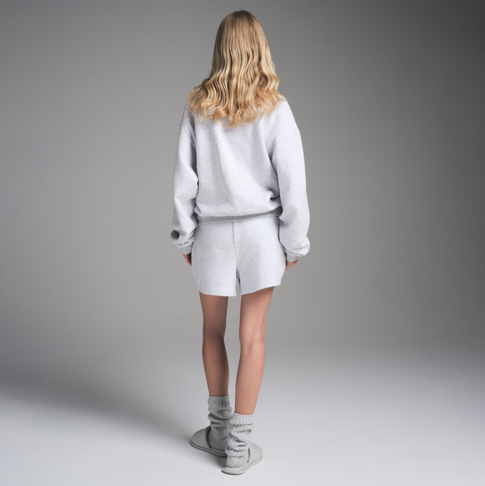 COTTON FLEECE CLASSIC CREWNECK | LIGHT HEATHER GREY ON A MODEL FRONT VIEW | FOCUS: 0.0, 1.0, 0.9