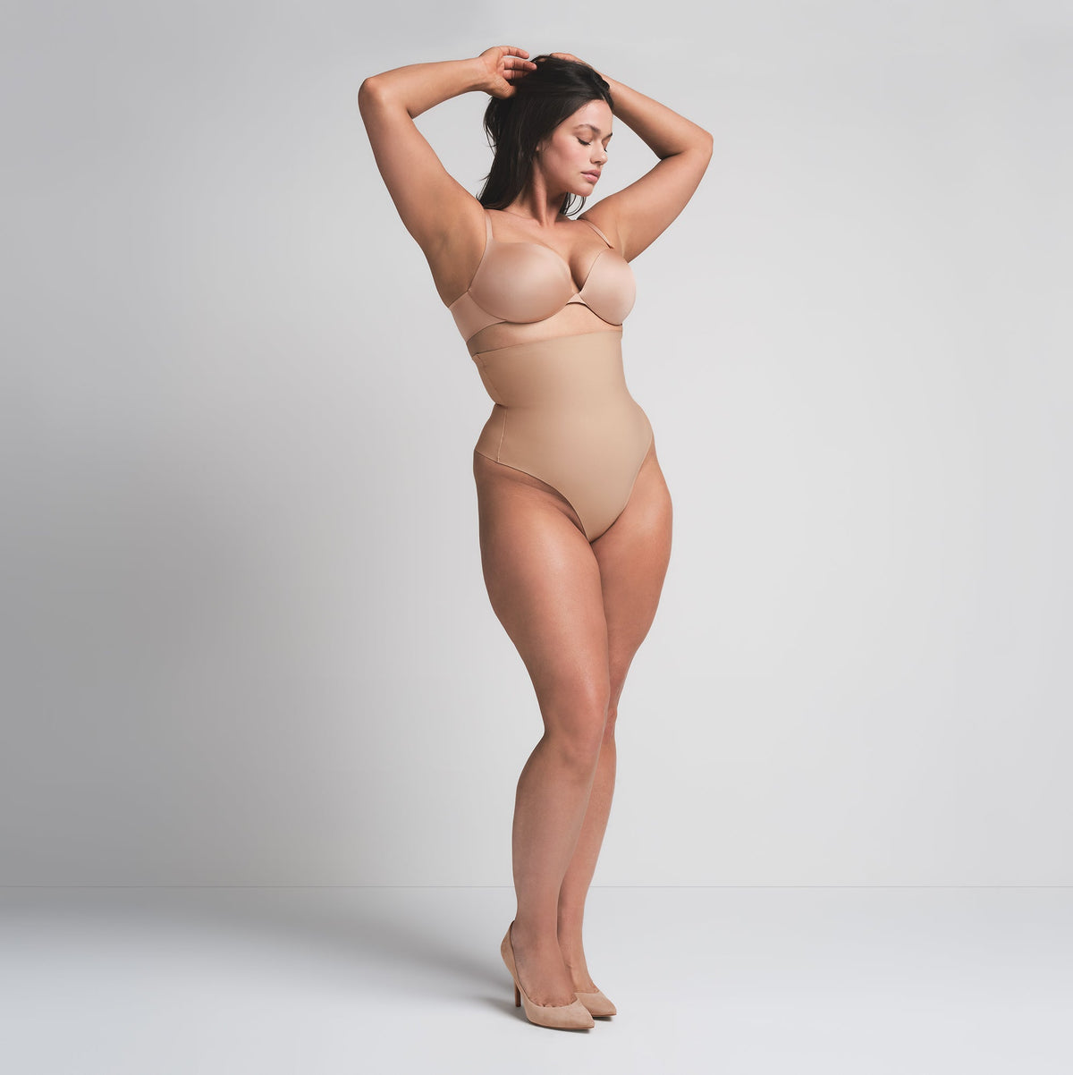 SKIMS BODY CORE SCULPT HIGH-WAISTED THONG | CLAY ON A MODEL FRONT VIEW