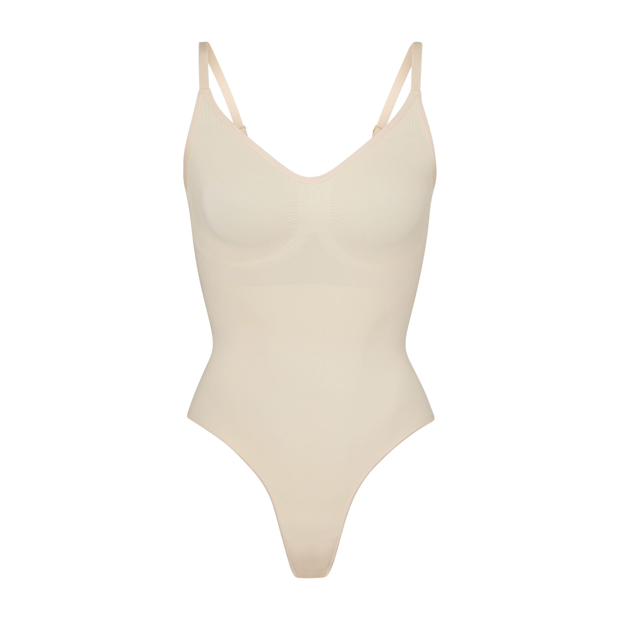 SEAMLESS SCULPT THONG BODYSUIT | SAND (SHAPEWEAR BODYSUITS) LAYS FLAT ON A WHITE BACKGROUND | FLT