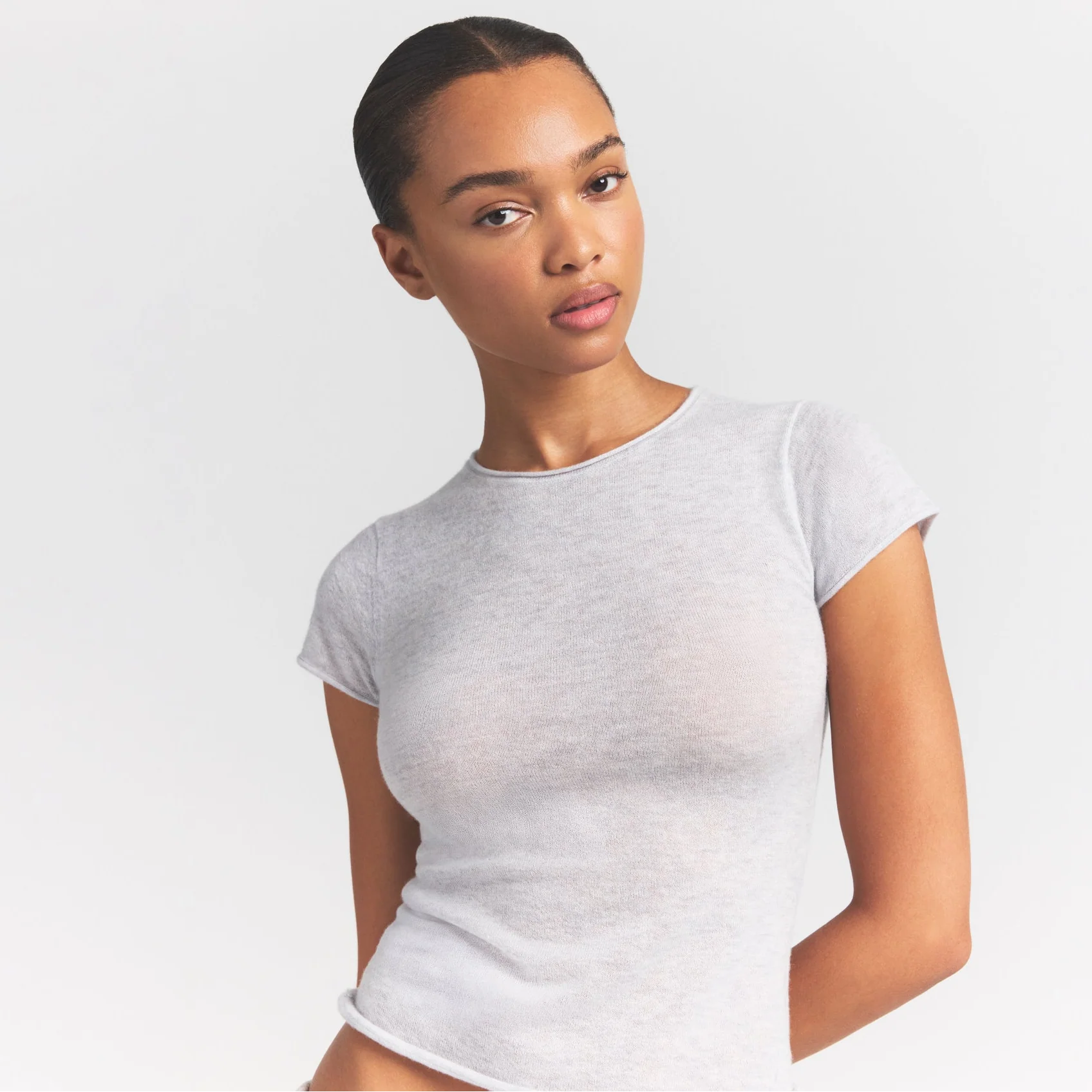 FEATHERWEIGHT CASHMERE TEE | LIGHT HEATHER GREY ON A MODEL SIDE VIEW S | FOCUS: 0.0, 1.0, 0.9