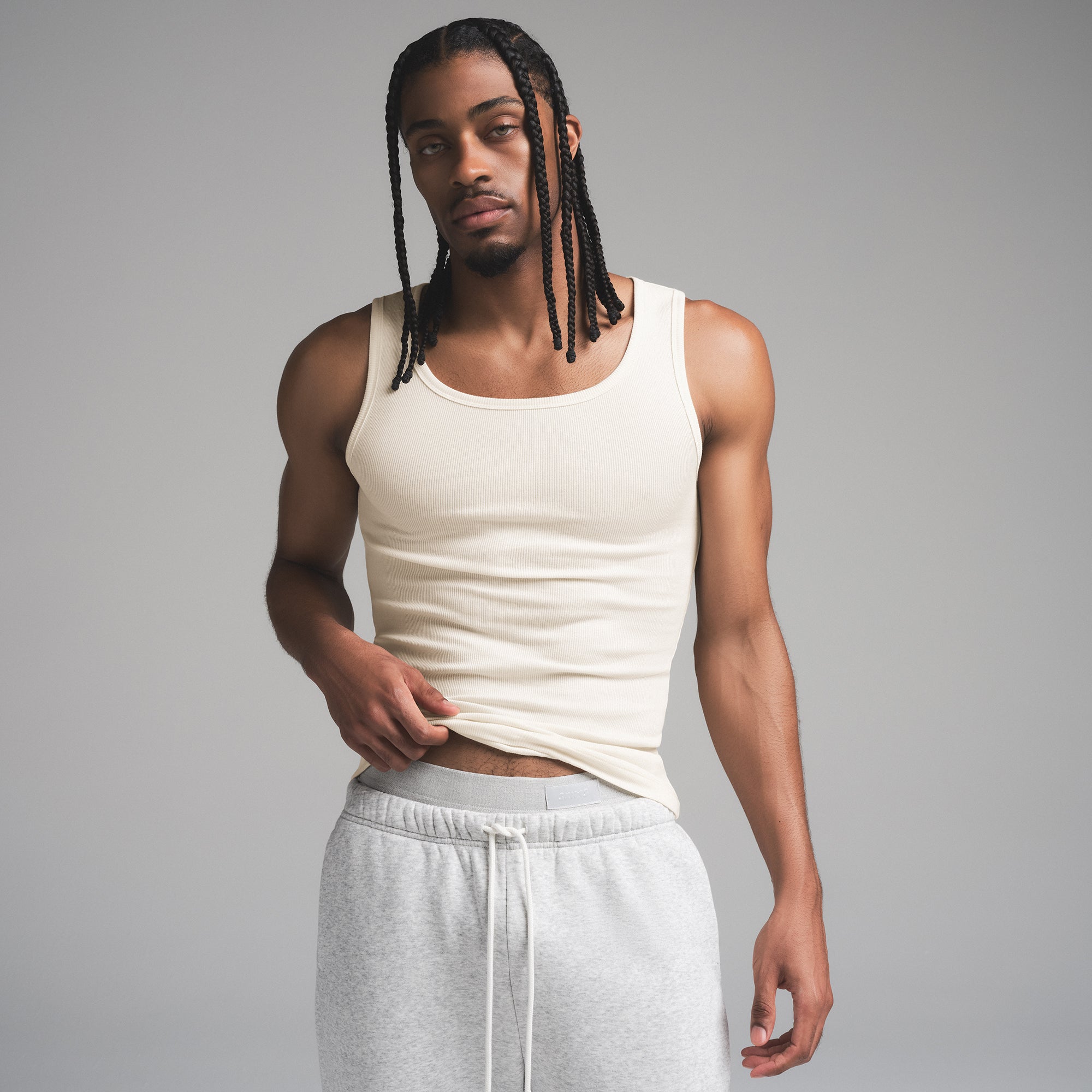 SKIMS COTTON MENS RIB TANK 3-PACK | ECRU MULTI ON A MODEL SIDE VIEW | FOCUS: 0.0, 1.0, 0.9