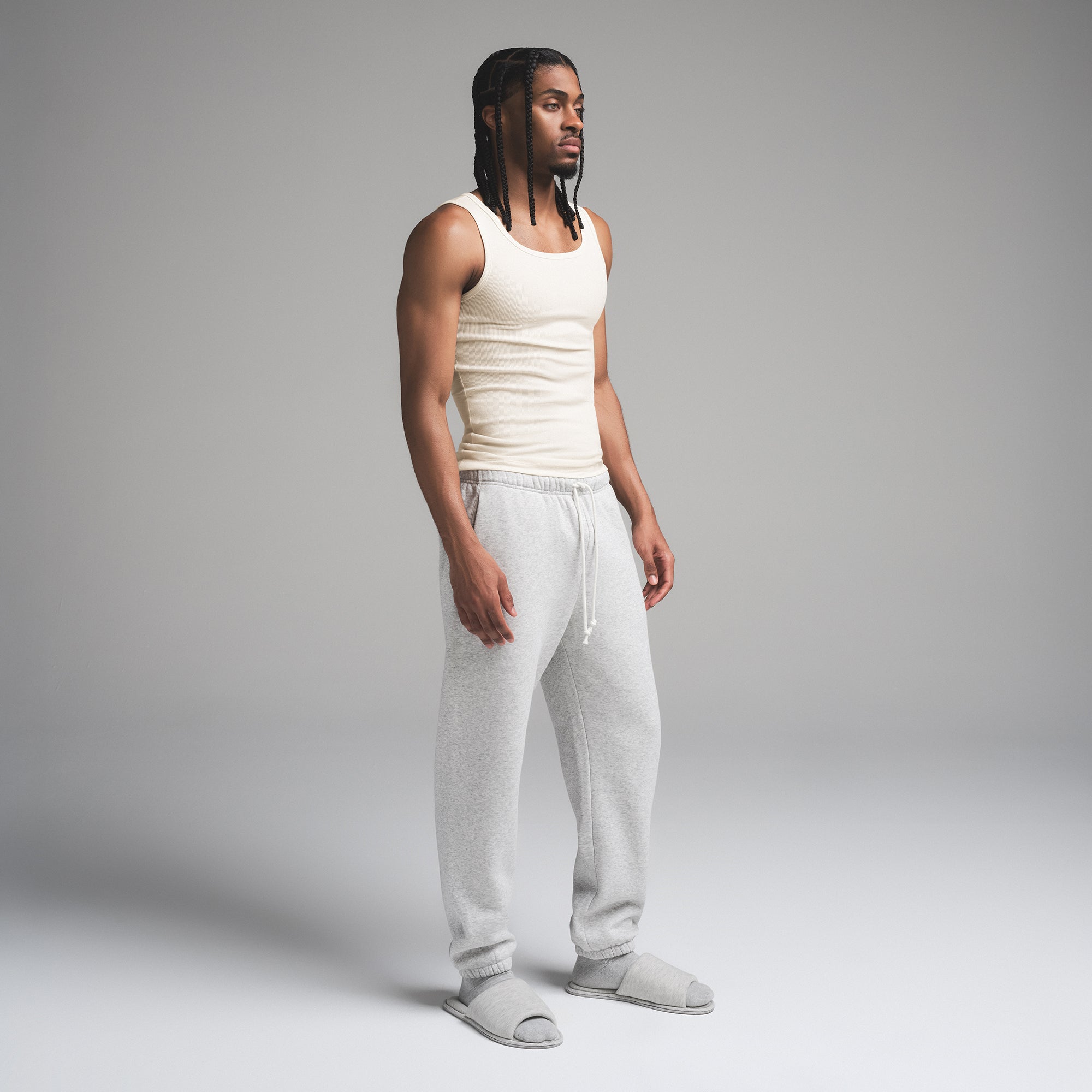 SKIMS COTTON MENS RIB TANK 3-PACK | ECRU MULTI ON A MODEL SIDE VIEW | FOCUS: 0.0, 1.0, 0.9