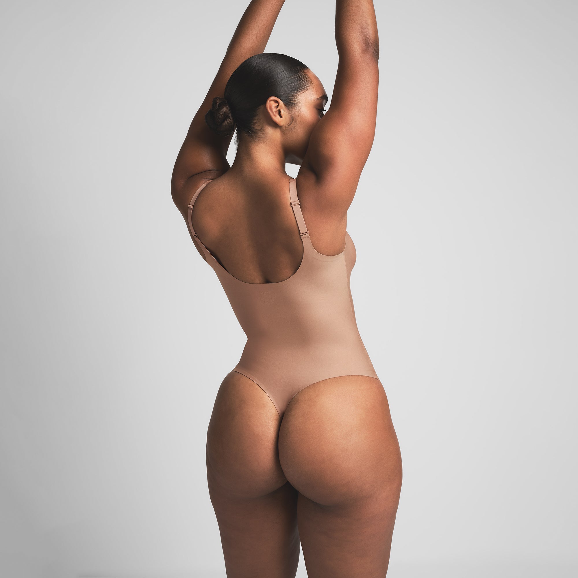 SKIMS BODY UNLINED PLUNGE THONG BODYSUIT | SIENNA ON A MODEL BACK VIEW | FOCUS: 0.0, 1.0, 0.9