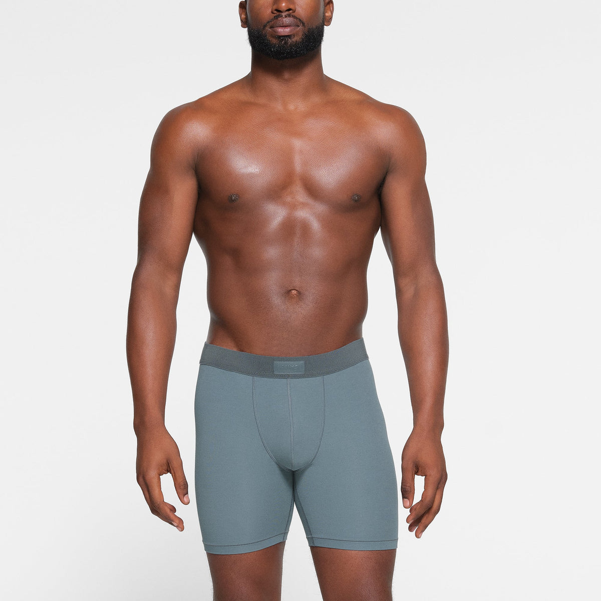 SKIMS COTTON MENS 5" BOXER BRIEF 3-PACK WORN BY A MODEL IN FRONT VIEW