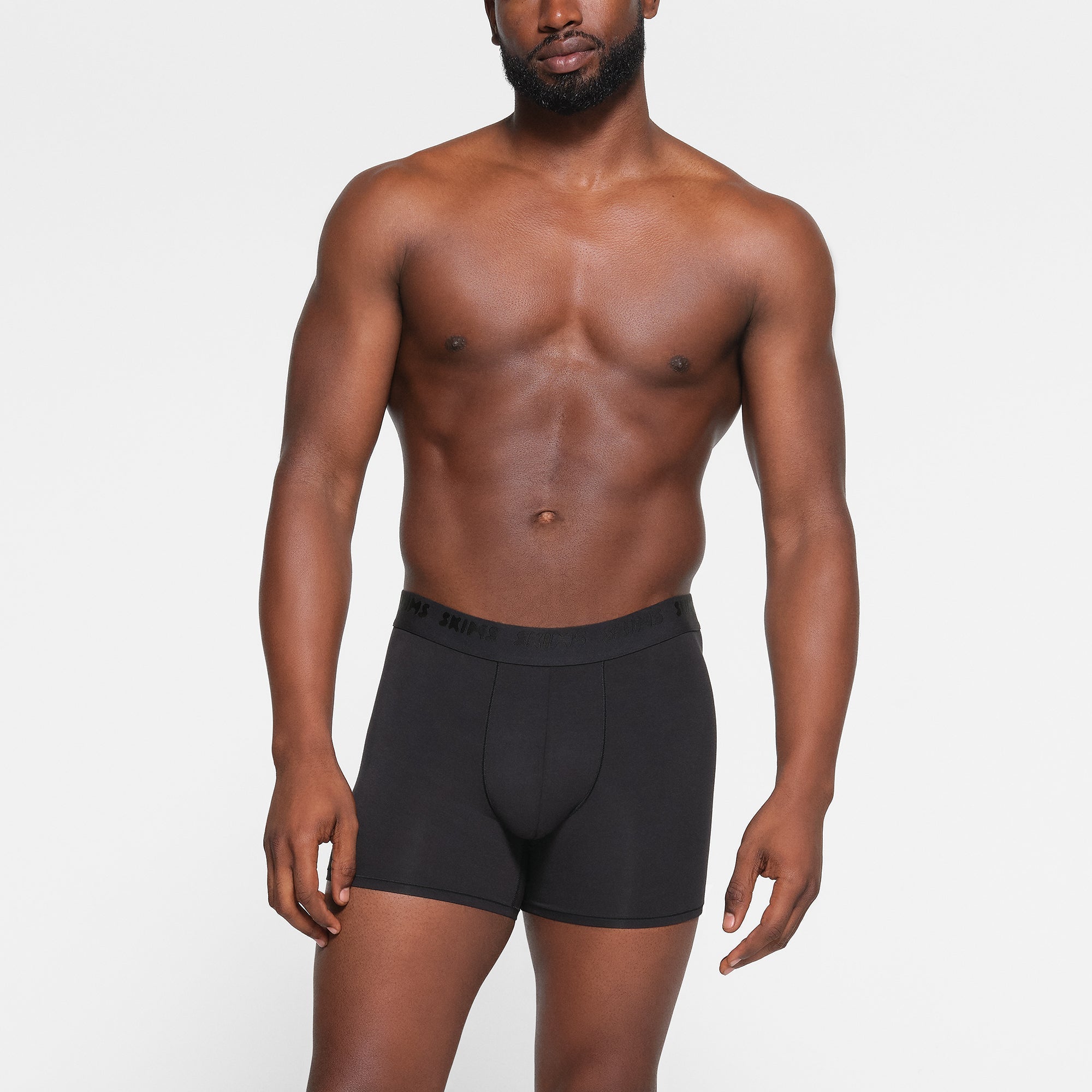 SKIMS STRETCH MENS 3" BOXER BRIEF 3-PACK WORN BY A MODEL IN FRONT VIEW