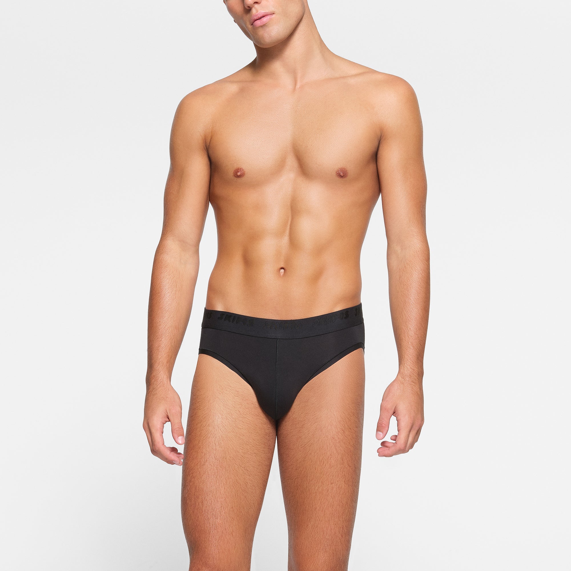SKIMS STRETCH MENS BRIEF 3-PACK WORN BY A MODEL IN FRONT VIEW