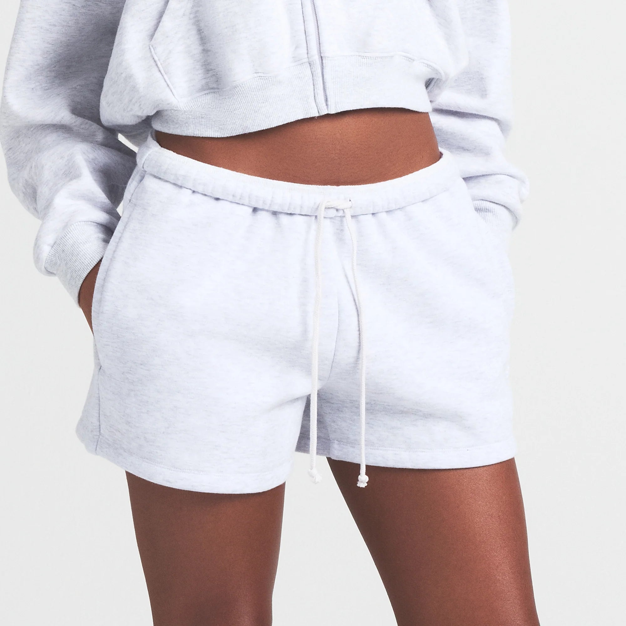 COTTON FLEECE CLASSIC SHORT | LIGHT HEATHER GREY ON A MODEL FRONT VIEW S | FOCUS: 0.0, 1.0, 0.9