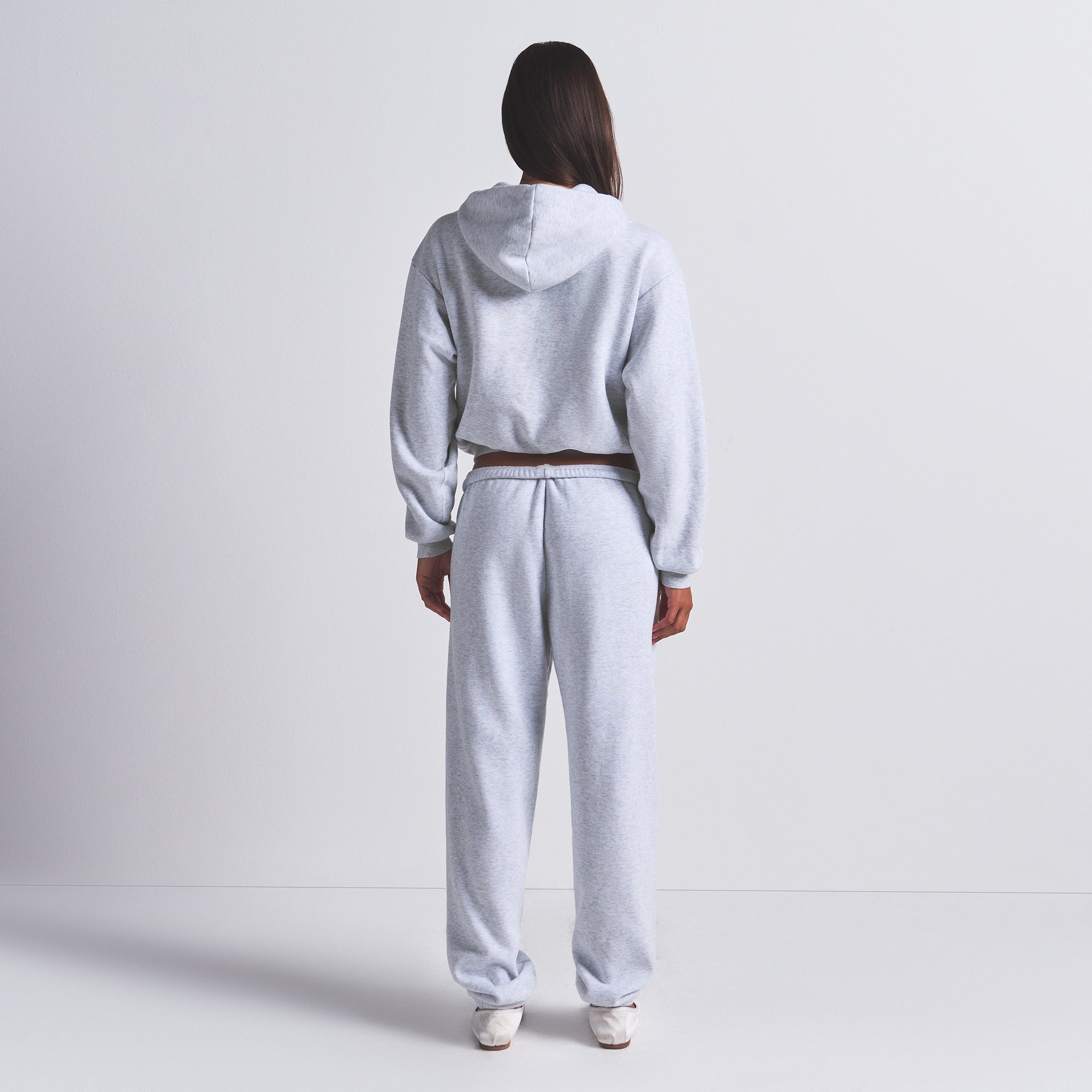 COTTON FLEECE CLASSIC HOODIE | LIGHT HEATHER GREY ON A MODEL FRONT VIEW | FOCUS: 0.0, 1.0, 0.9