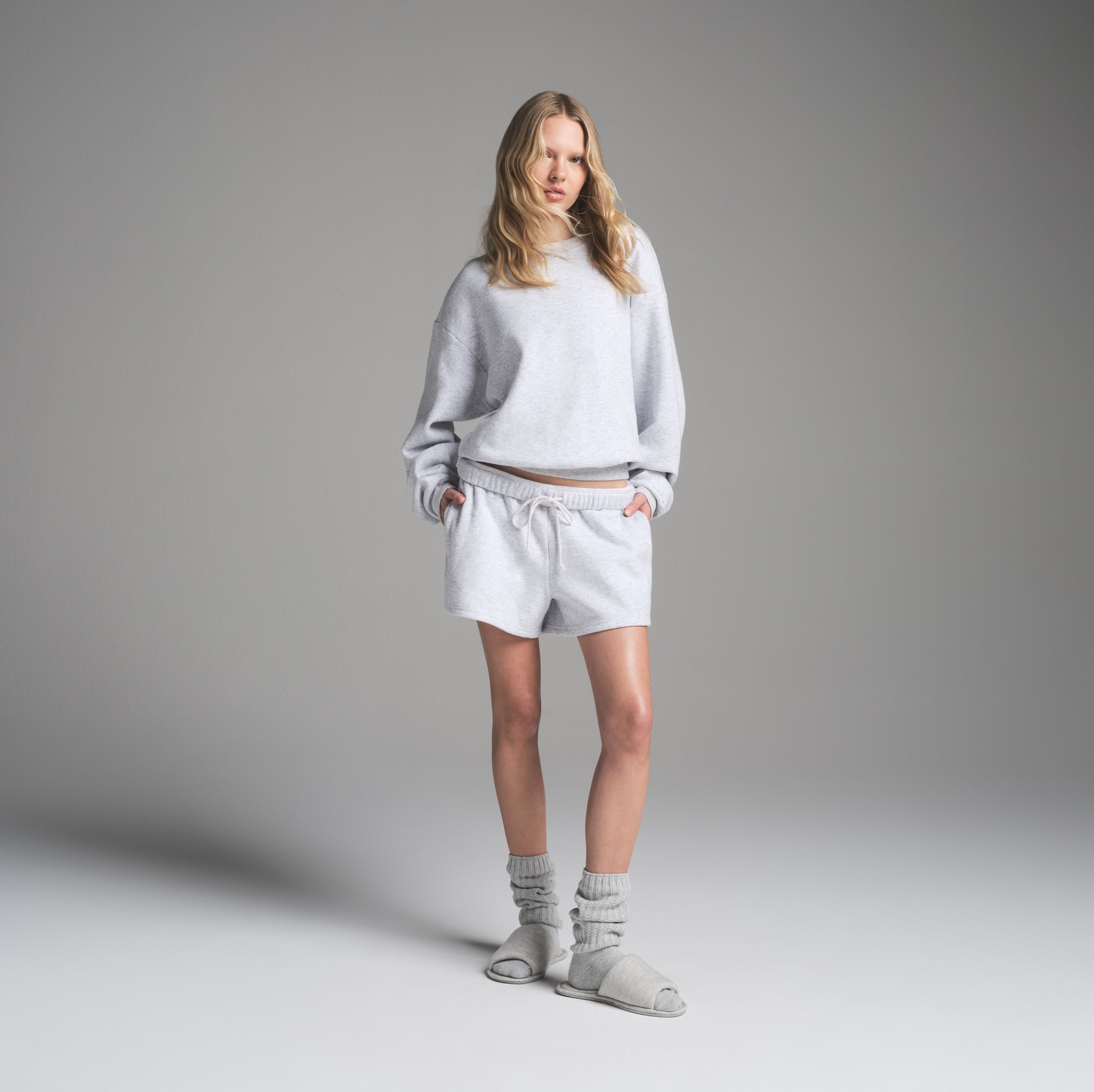 COTTON FLEECE CLASSIC CREWNECK | LIGHT HEATHER GREY ON A MODEL FRONT VIEW | FOCUS: 0.0, 1.0, 0.9
