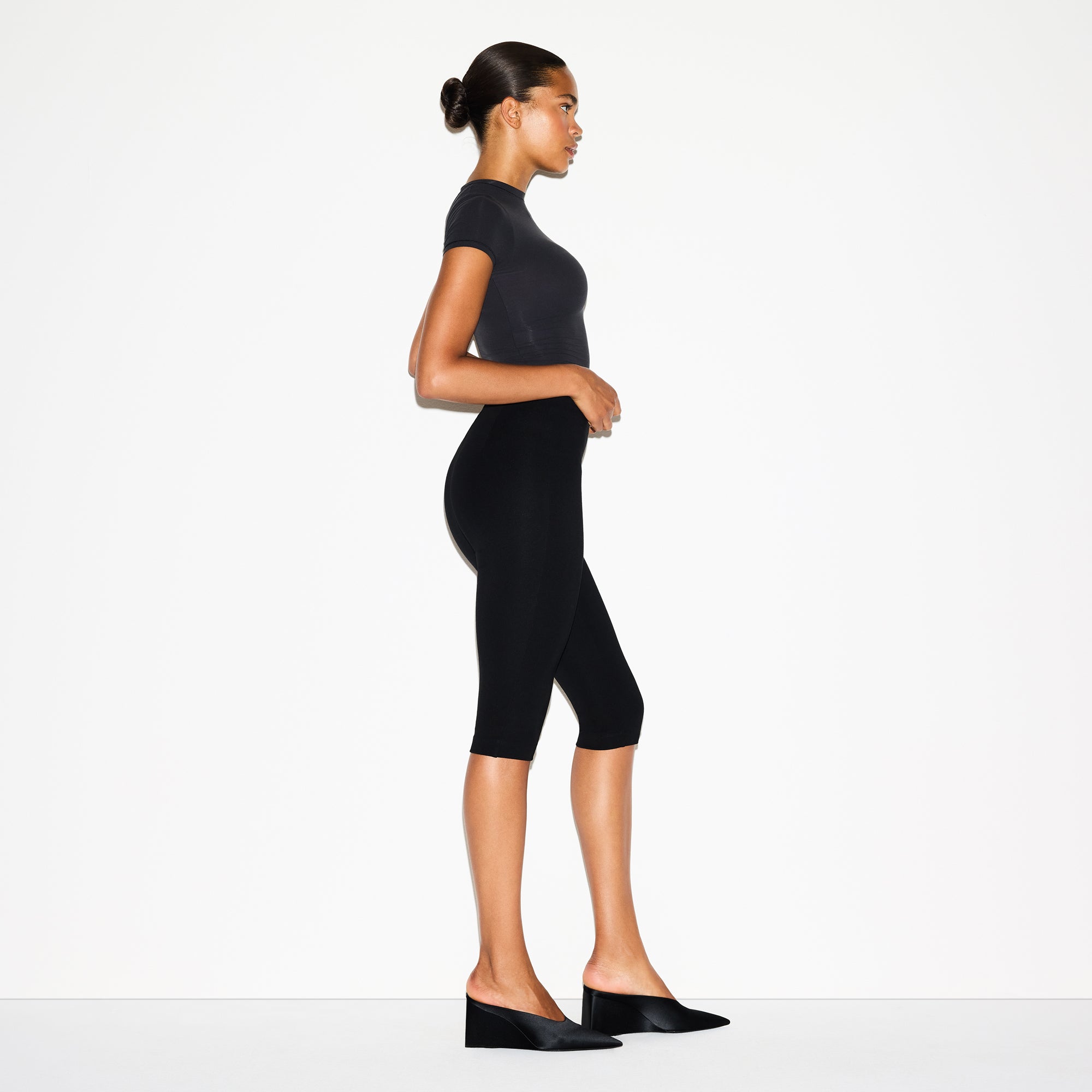 THE ESSENTIAL COLLECTION HIGH-WAISTED CAPRI | OBSIDIAN ON A MODEL FRONT VIEW @ | FOCUS: 0.0, 1.0, 0.9