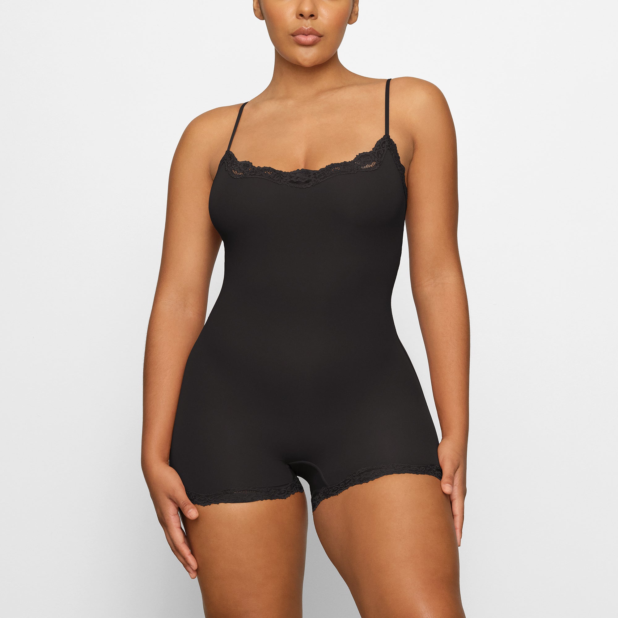 FITS EVERYBODY LACE ONESIE WORN BY A MODEL IN FRONT VIEW