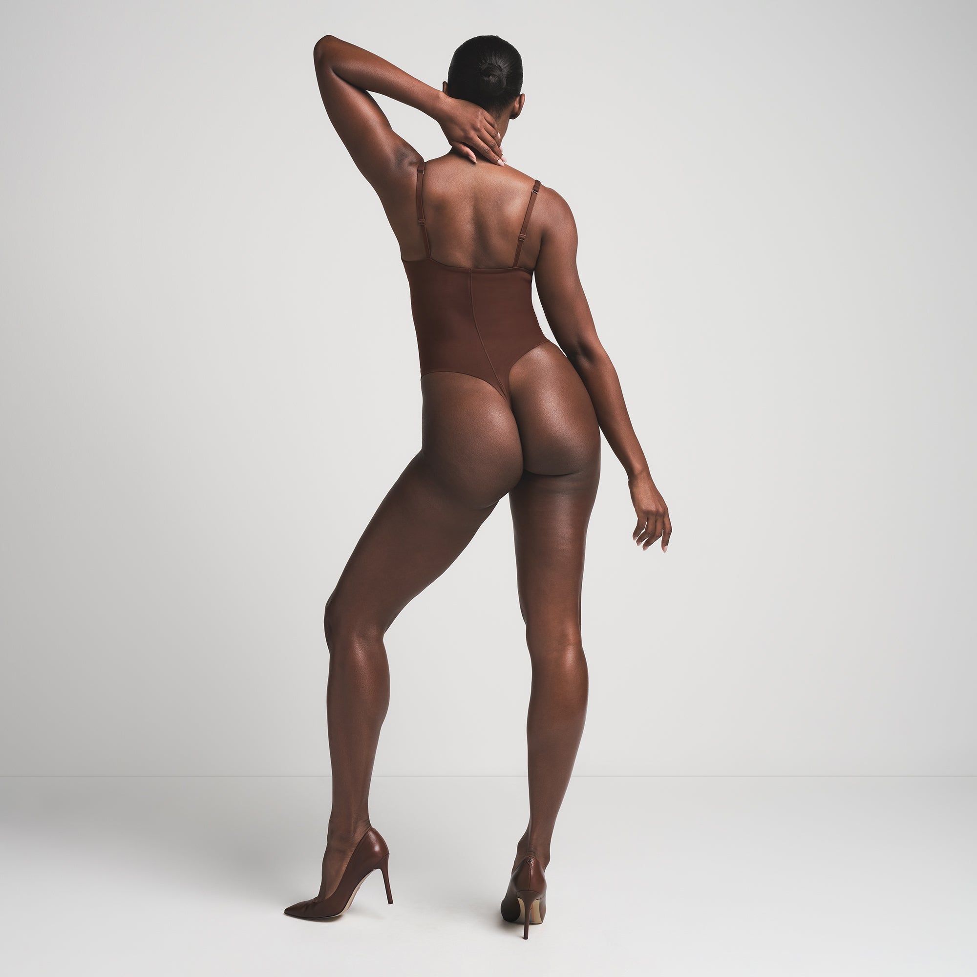 SKIMS ULTIMATE BODY PUSH-UP THONG BODYSUIT | COCOA  ON A MODEL BACK VIEW | FOCUS: 0.0, 1.0, 0.9