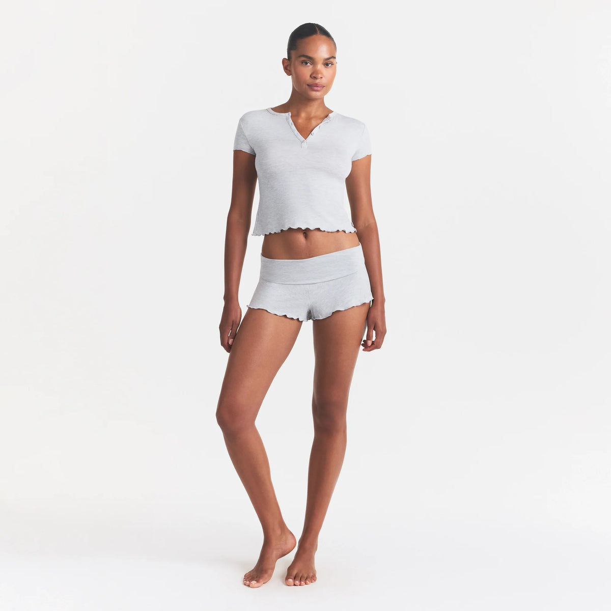 SKIMS SLEEP HENLEY AND FOLDOVER SHORT SET | LIGHT HEATHER GREY ON A MODEL FRONT VIEW @ | FOCUS: 0.0, 1.0, 0.9