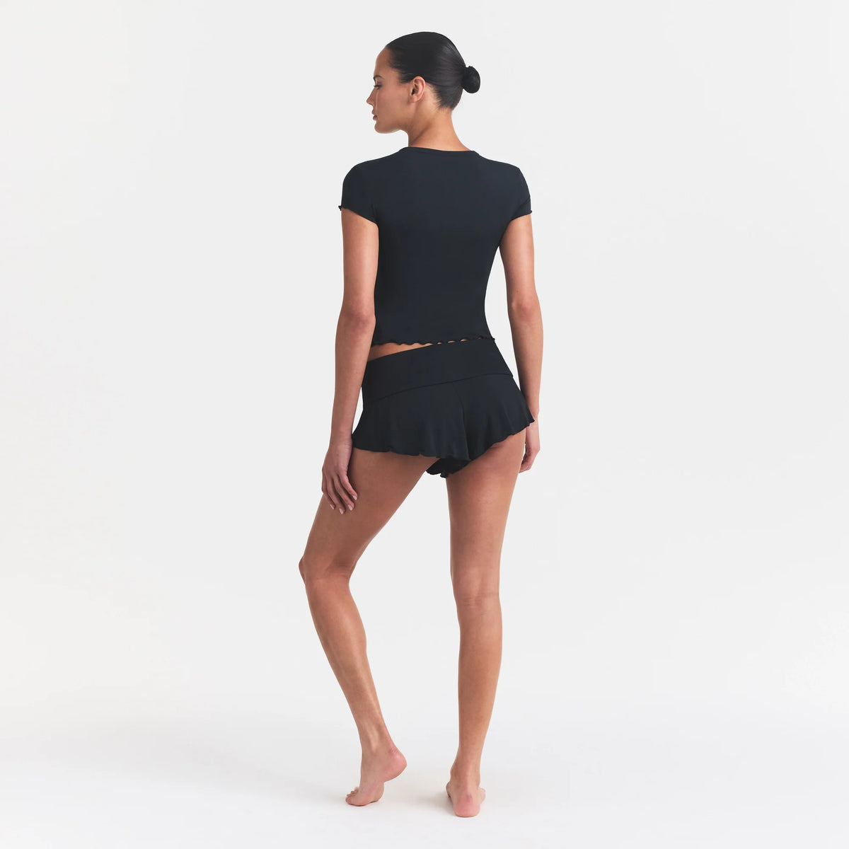 SKIMS SLEEP HENLEY AND FOLDOVER SHORT SET | ONYX ON A MODEL FRONT VIEW @ | FOCUS: 0.0, 1.0, 0.9