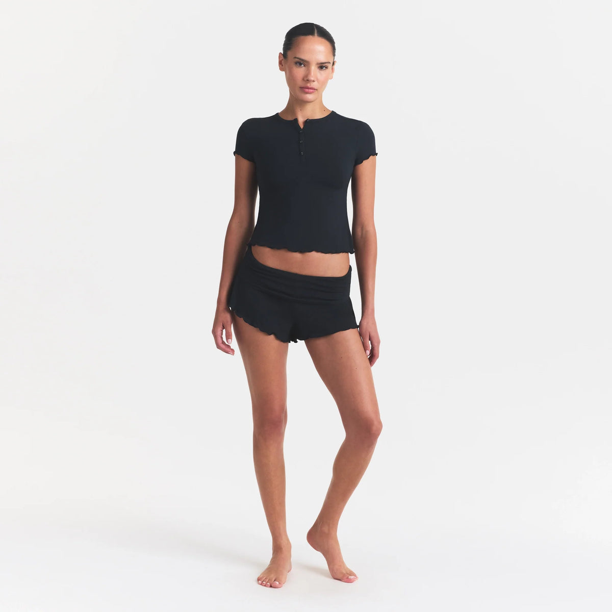 SKIMS SLEEP HENLEY AND FOLDOVER SHORT SET | ONYX ON A MODEL FRONT VIEW @ | FOCUS: 0.0, 1.0, 0.9