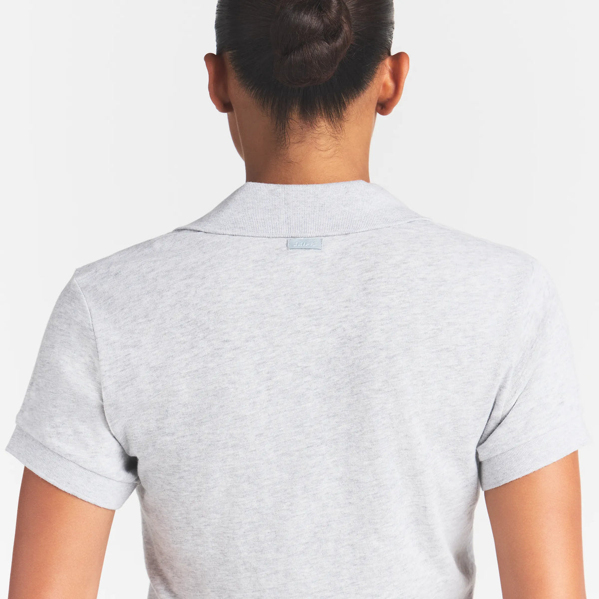 WORN IN JERSEY POLO | LIGHT HEATHER GREY ON A MODEL BACK VIEW