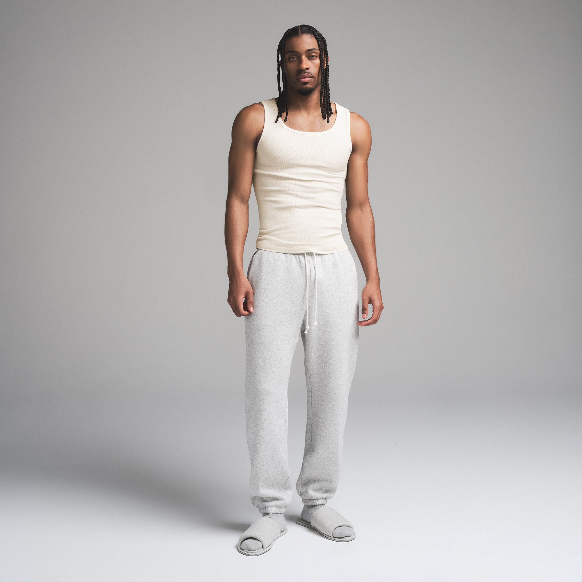 SKIMS COTTON MENS RIB TANK 3-PACK | ECRU MULTI ON A MODEL FRONT VIEW | FOCUS: 0.0, 1.0, 0.9