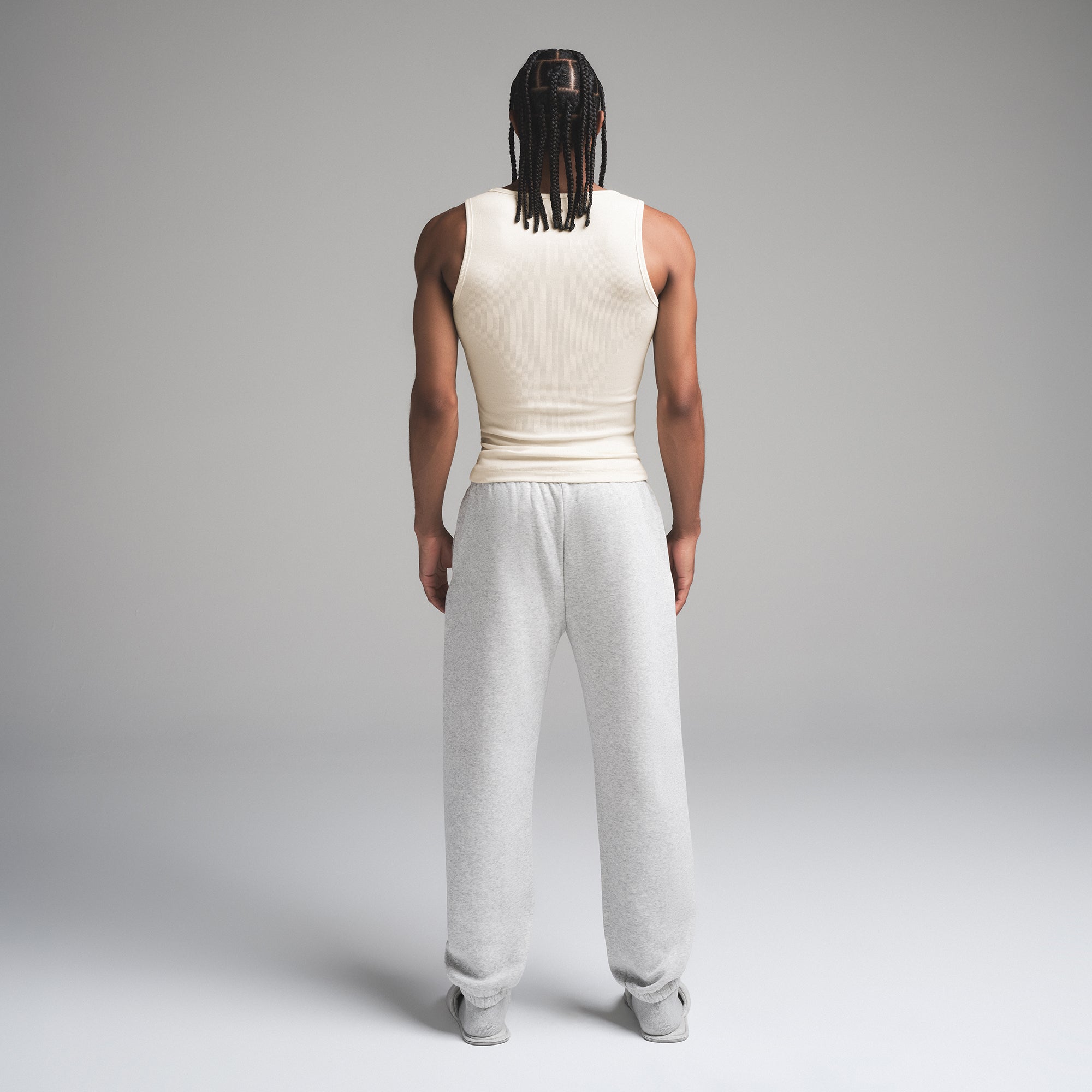 SKIMS COTTON MENS RIB TANK 3-PACK | ECRU MULTI ON A MODEL SIDE VIEW | FOCUS: 0.0, 1.0, 0.9