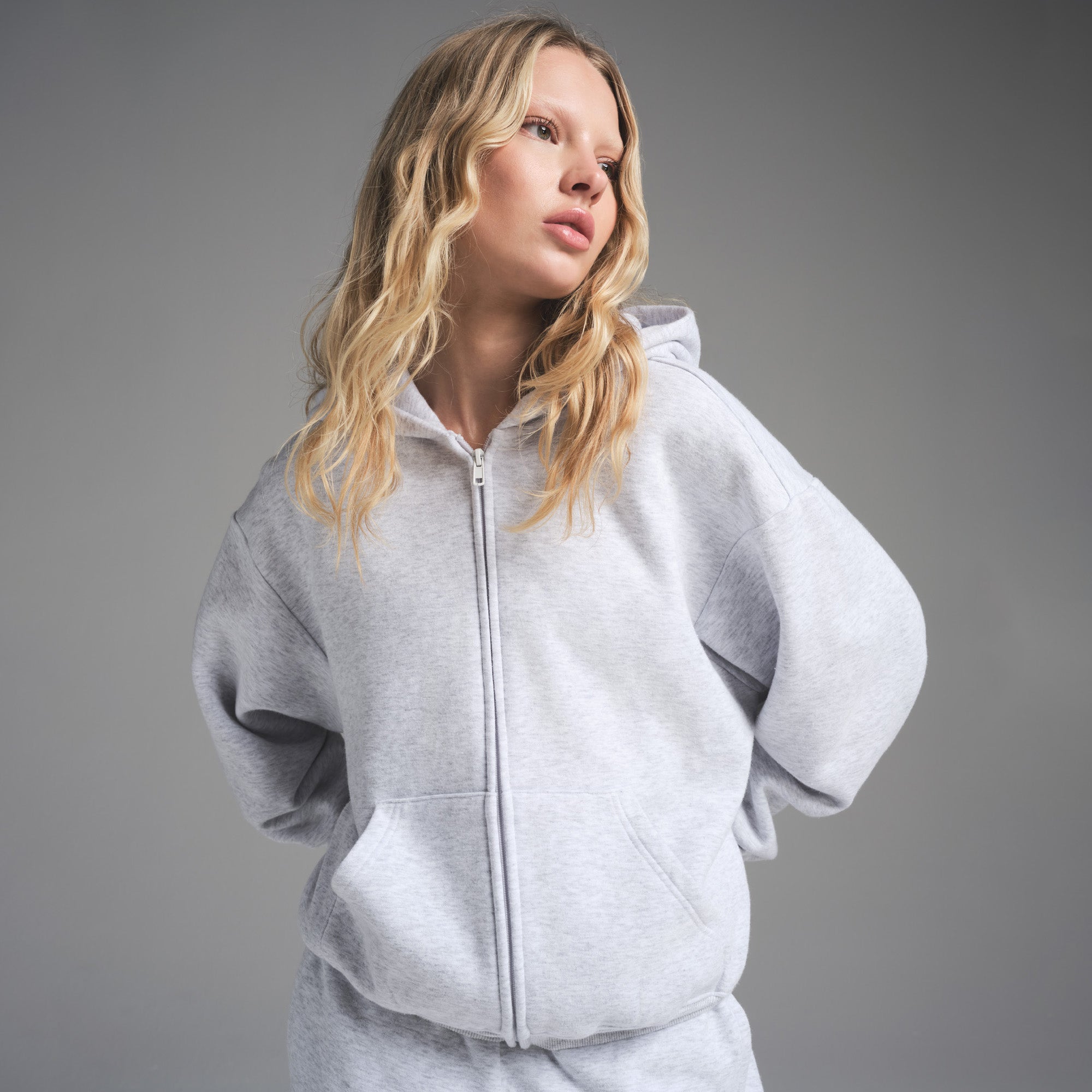 COTTON FLEECE CLASSIC ZIP UP HOODIE | LIGHT HEATHER GREY ON A MODEL FRONT VIEW | FOCUS: 0.0, 1.0, 0.9